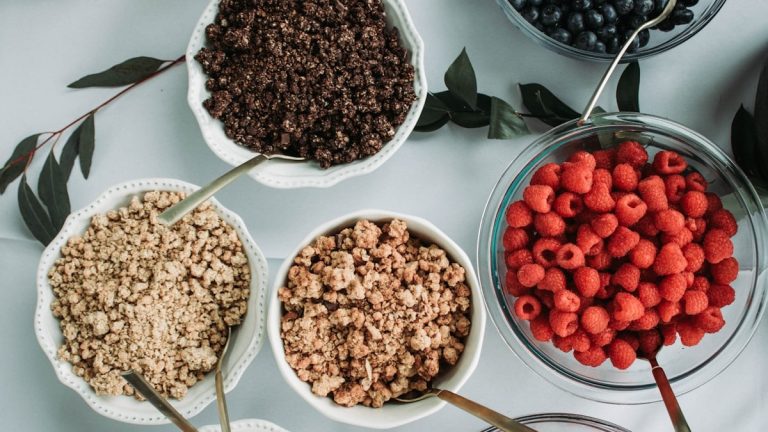 red strawberries on white ceramic bowls